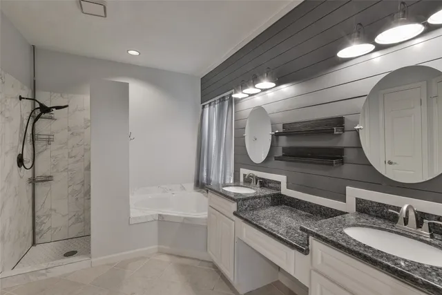 a bathroom with a granite countertop sink a toilet and a shower