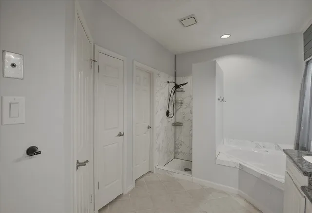 a bathroom with a shower and a bath tub