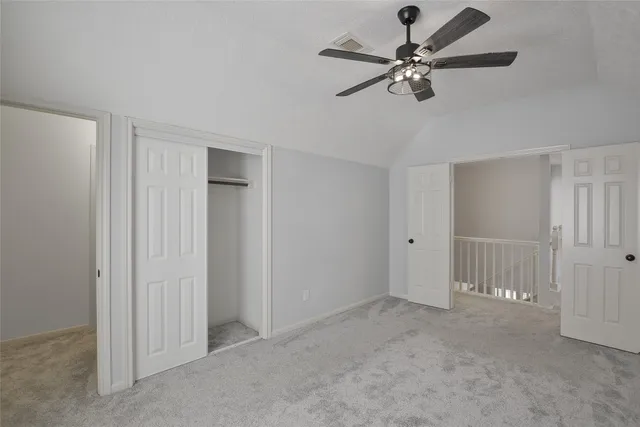 an empty room with windows and closet