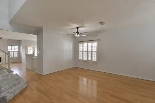 wooden floor in an empty room with a window