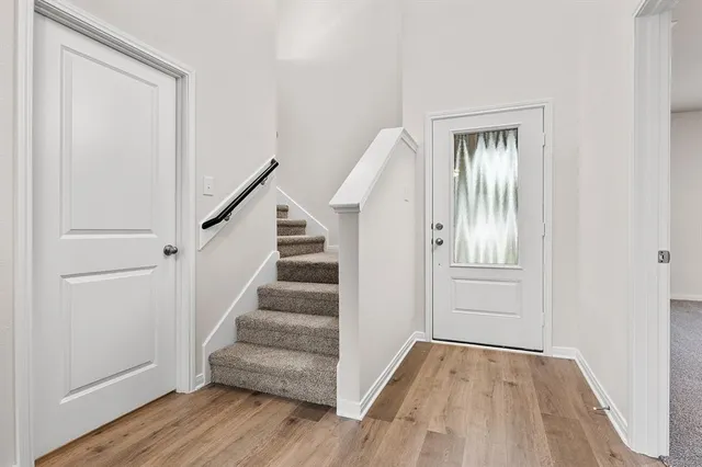 a view of an entryway with wooden floor and staircase