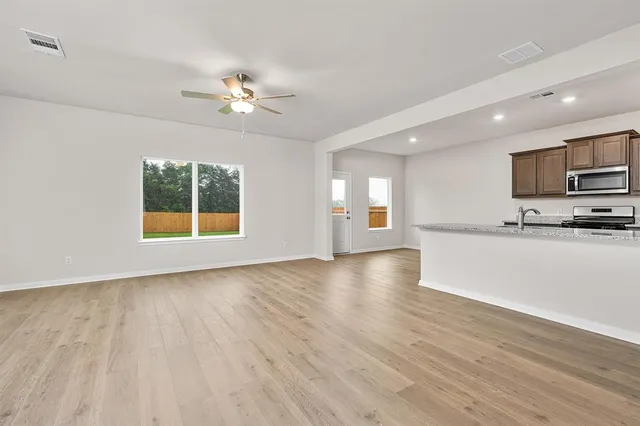 a view of kitchen with sink and wooden floor