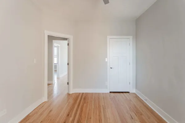 a view of an empty room and wooden floor