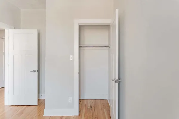 a view of a hallway with wooden floor