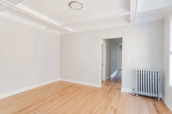a view of a room with wooden floor