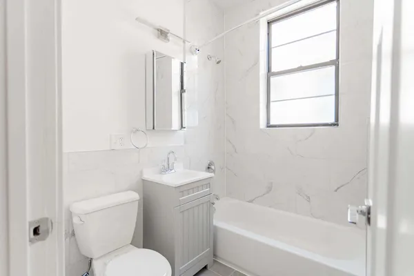 a bathroom with a toilet a sink and a bathtub