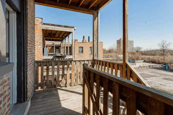 a view of a balcony with wooden floor