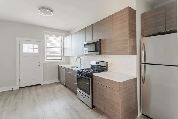 a kitchen with a refrigerator stove and microwave