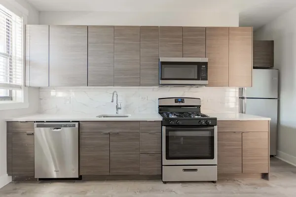 a kitchen with granite countertop a stove and a sink