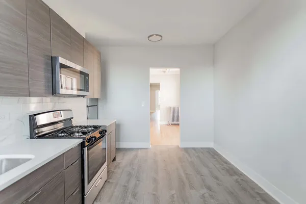 a kitchen that has a microwave and a stove