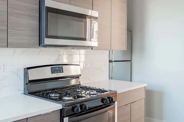 a stove top oven sitting inside of a kitchen