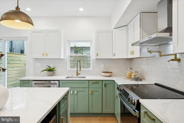 a kitchen with a sink a stove and cabinets