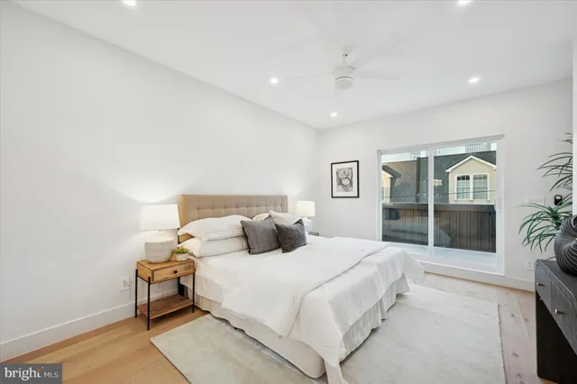 a bedroom with a bed and a large window