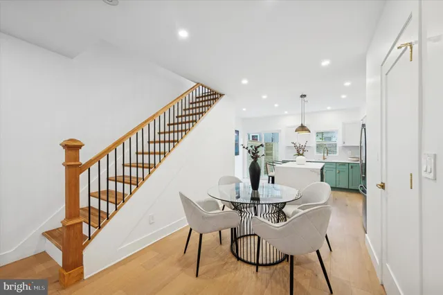 a view of a dining room with furniture a rug and wooden floor