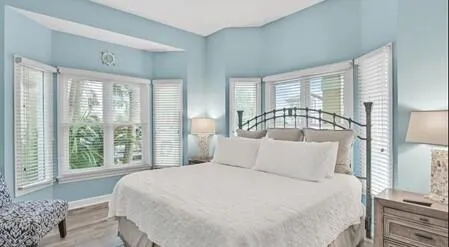 a bedroom with a large bed and a large window
