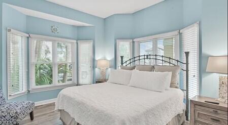 4765 Calatrava Court Destin, FL 32541 - Photo 12 of 34 a bedroom with a large bed and a large window