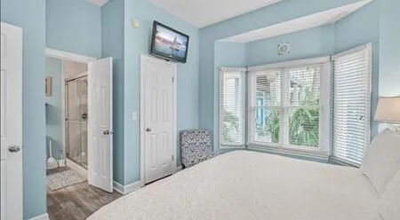 a bedroom with a bed and a large window