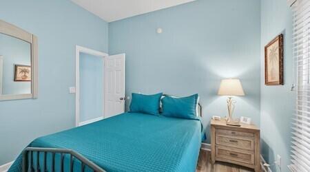 4765 Calatrava Court Destin, FL 32541 - Photo 15 of 34 a bedroom with a bed and a lamp on the dresser
