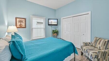 4765 Calatrava Court Destin, FL 32541 - Photo 16 of 34 a bedroom with a bed and wooden floor