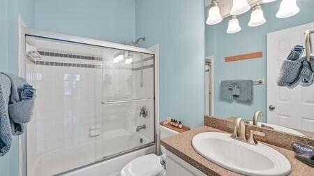 4765 Calatrava Court Destin, FL 32541 - Photo 19 of 34 a bathroom with a granite countertop sink toilet and shower