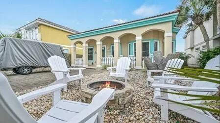 a front view of a house with patio furniture