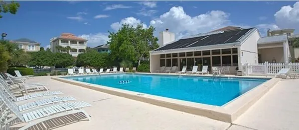 a view of swimming pool with outdoor seating and yard in back