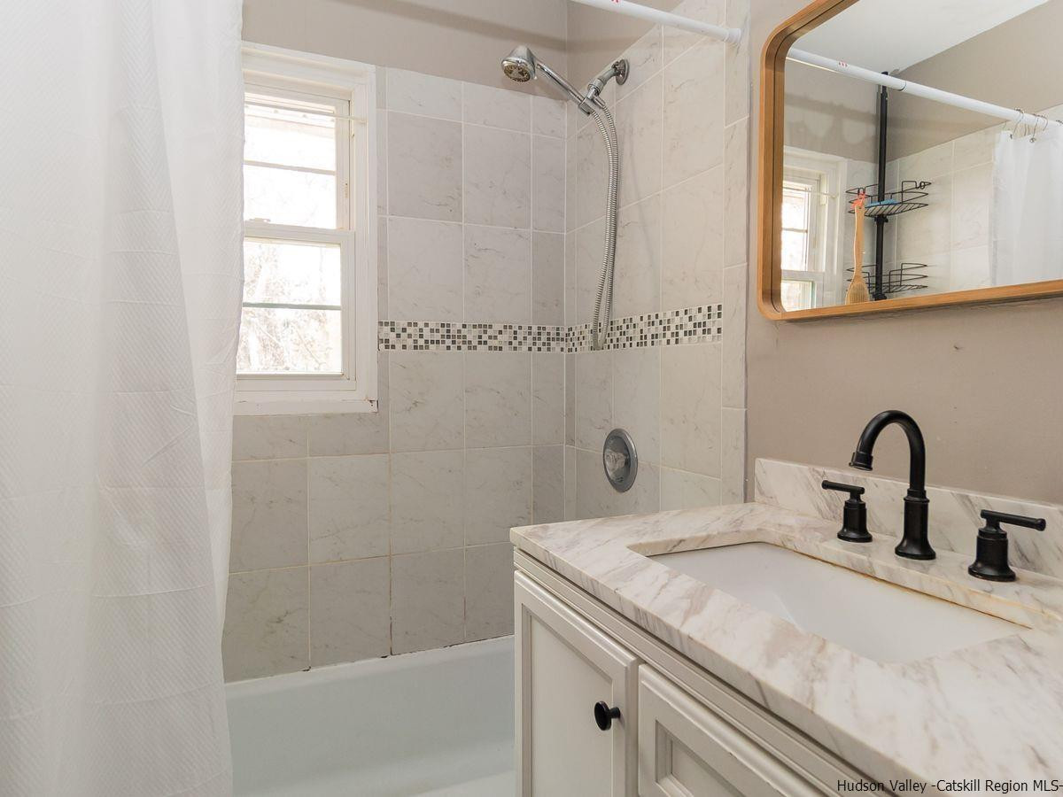2710 South Road, Unit E4 Poughkeepsie, NY 12601 - Photo 11 of 13 a bathroom with a sink and a mirror