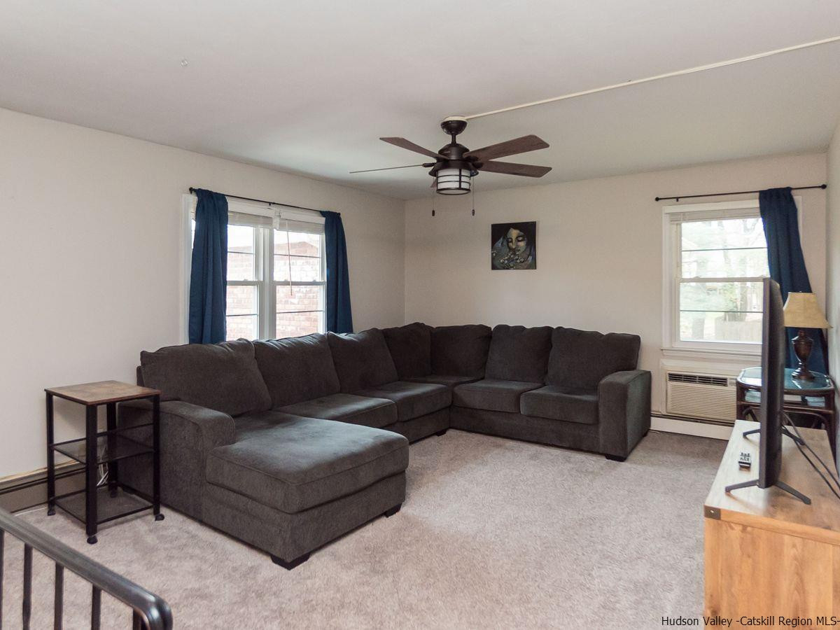 2710 South Road, Unit E4 Poughkeepsie, NY 12601 - Photo 2 of 13 a living room with furniture and a flat screen tv