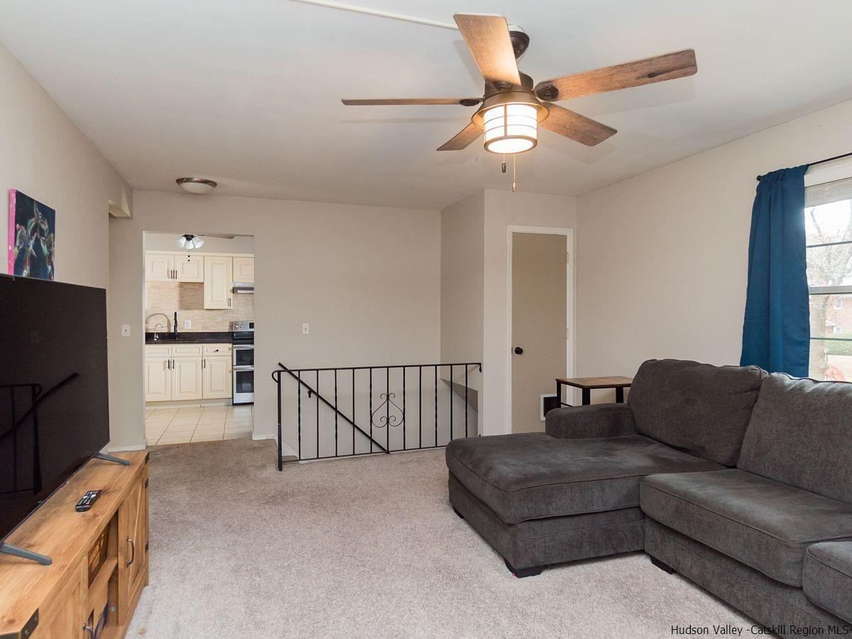 2710 South Road, Unit E4 Poughkeepsie, NY 12601 - Photo 4 of 13 a living room with furniture and a flat screen tv