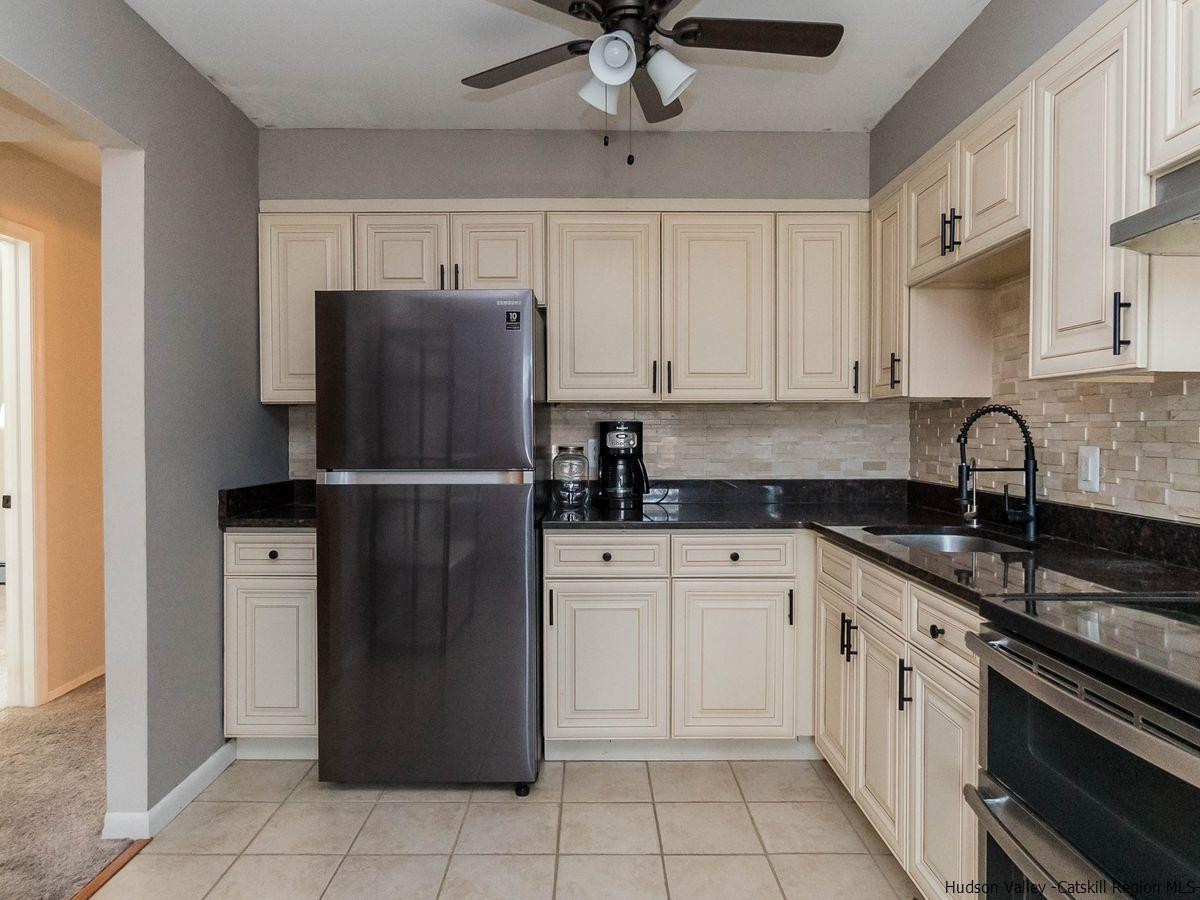 2710 South Road, Unit E4 Poughkeepsie, NY 12601 - Photo 6 of 13 a kitchen with a refrigerator sink and cabinets