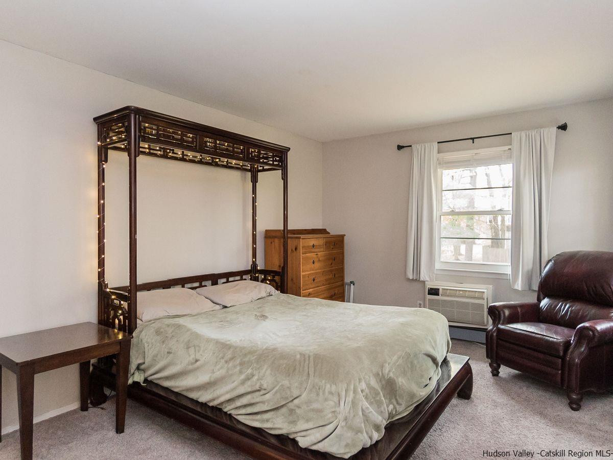 2710 South Road, Unit E4 Poughkeepsie, NY 12601 - Photo 9 of 13 a bedroom with a bed window and couch