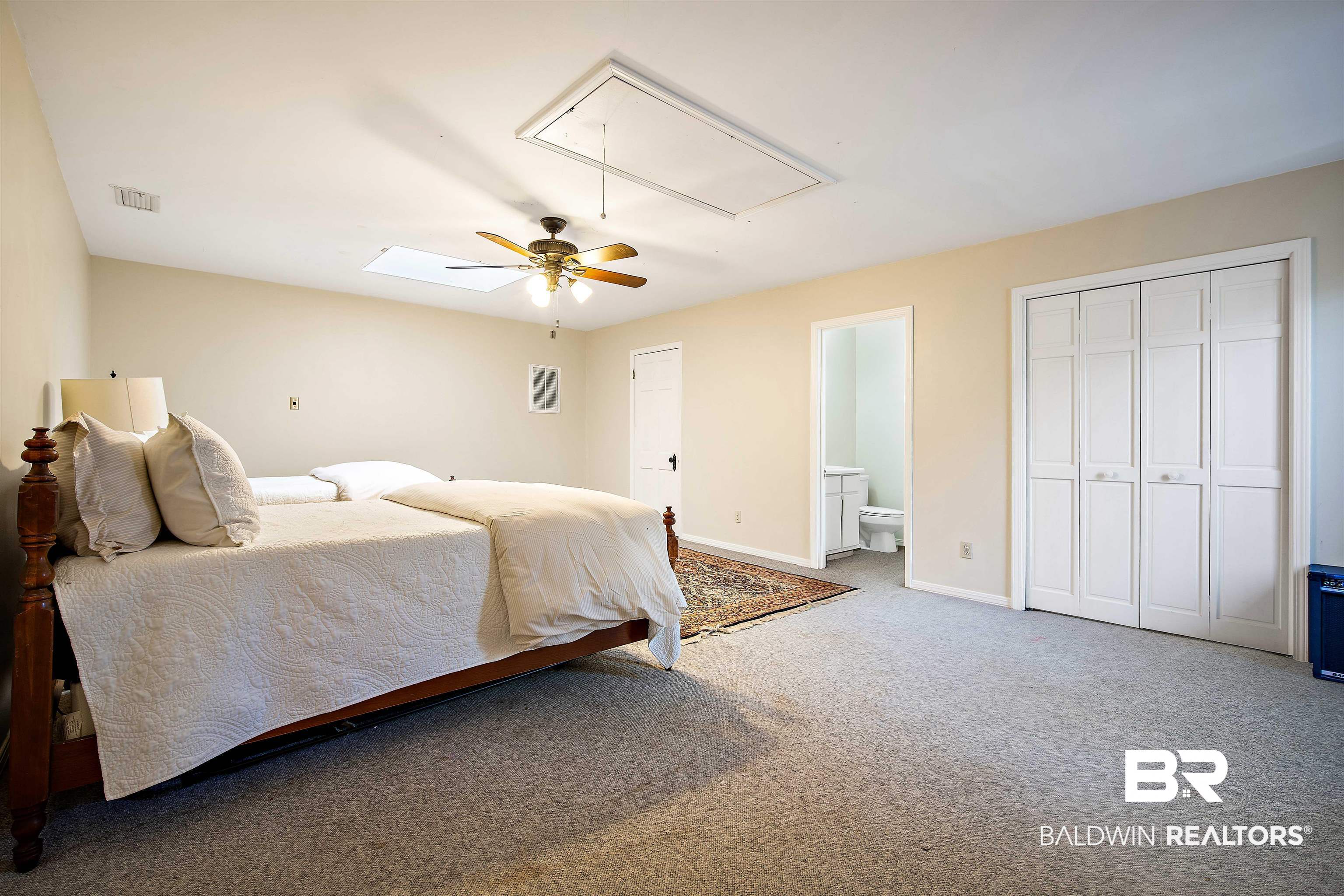 1314 Dauphin Street Mobile, AL 36604 - Photo 44 of 61 Carpeted bedroom with ensuite bath and ceiling fan