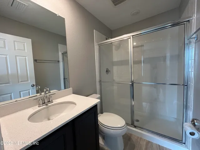 a bathroom with a sink toilet and shower