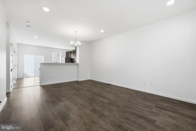 a view of a kitchen with a sink and a refrigerator