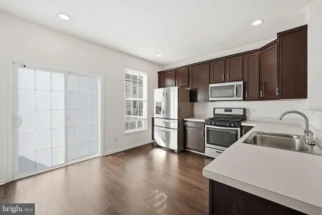 a kitchen with wooden cabinets and stainless steel appliances