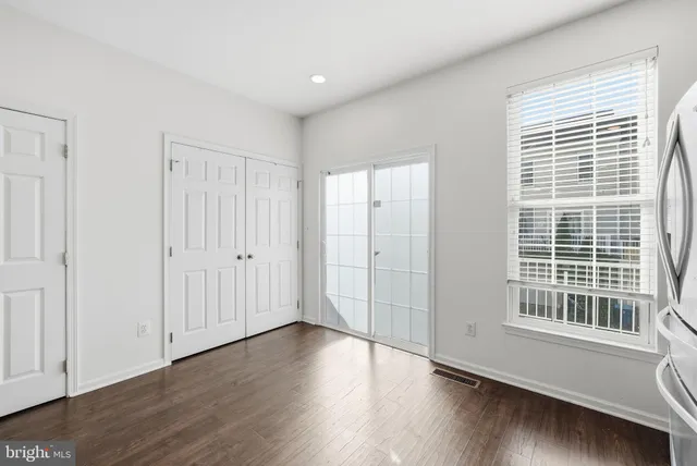 a view of a livingroom with wooden floor and windows