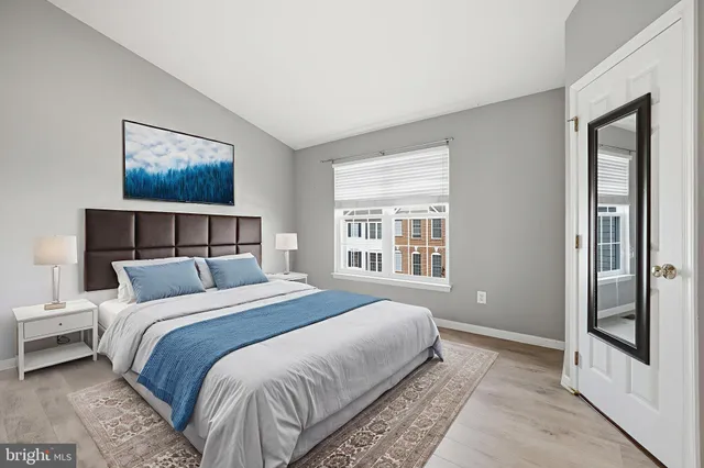 a bedroom with a bed and a painting on the wall