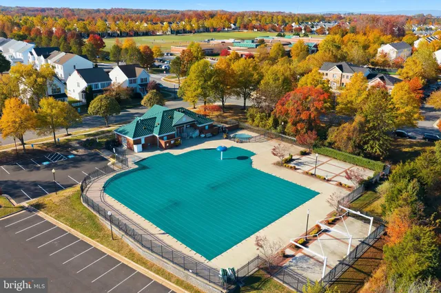 an aerial view of a residential houses with outdoor space