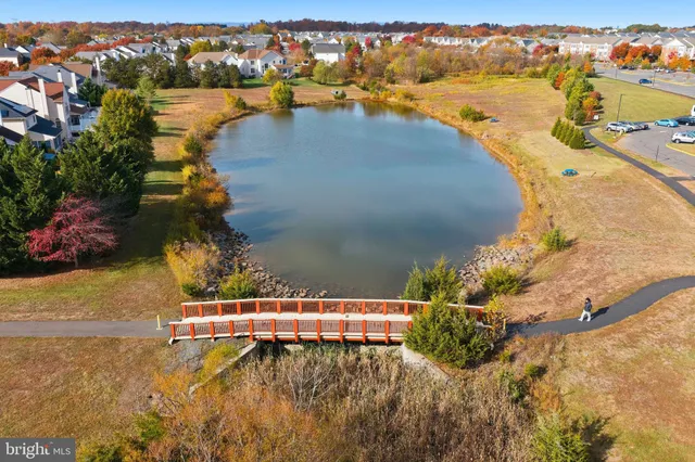 a front view of a building with cars parked