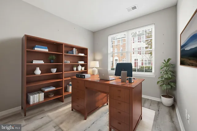 a dining room with a large window and a potted plant