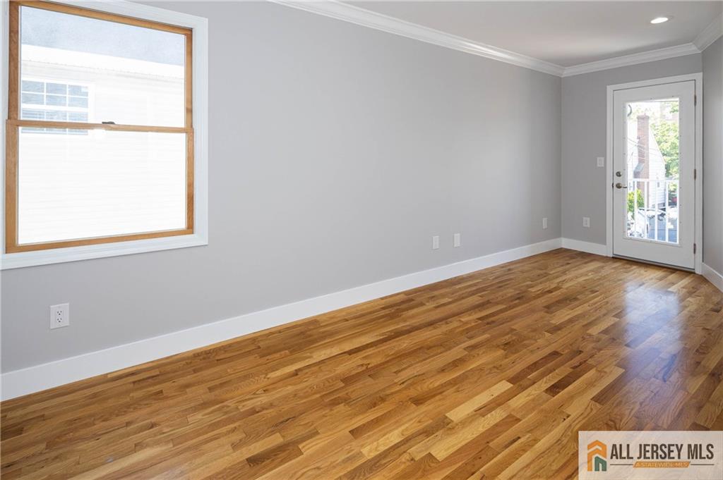 278 Rector Street Perth Amboy, NJ 08861 - Photo 25 of 47 an empty room with wooden floor and windows