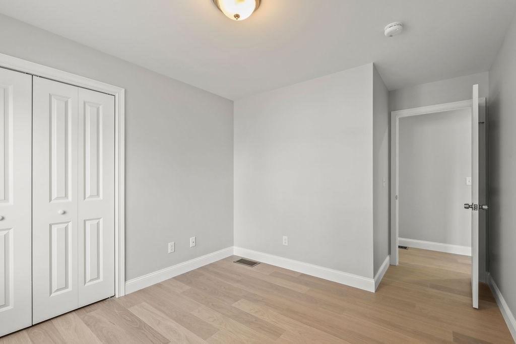 81 Maple Springs Road Wareham, MA 02571 - Photo 12 of 17 a view of an empty room with wooden floor