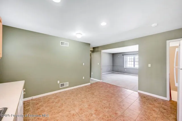 a view of a big room with closet and windows