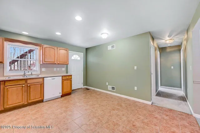 a view of a kitchen with a sink and a dishwasher