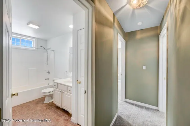a bathroom with a toilet a sink and shower