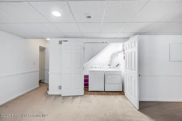 a view of storage and utility room with washer and dryer
