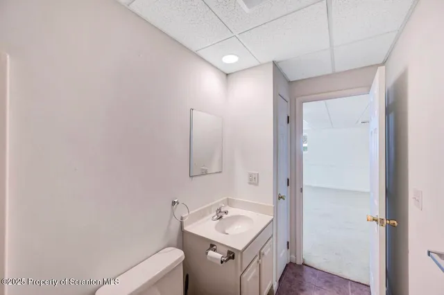 a bathroom with a sink mirror and vanity