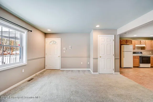 an empty room with windows and pillars in it