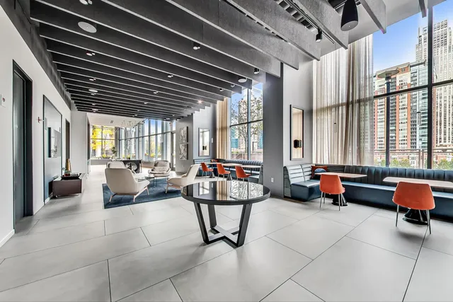 a living room with patio furniture and a large window
