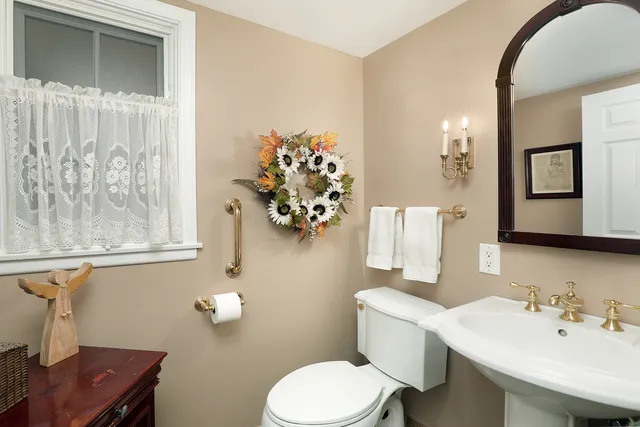 a bathroom with a toilet sink and mirror
